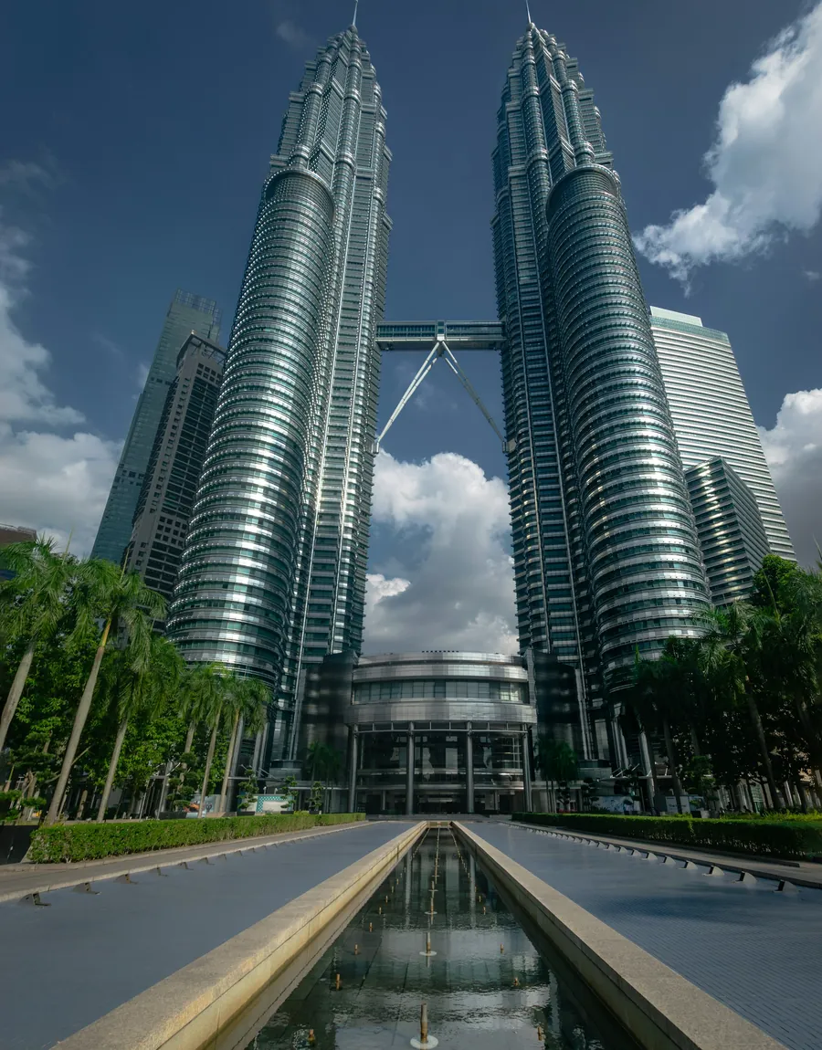 The Petronas Twin Towers above a reflecting pool in central Kuala Lumpur.